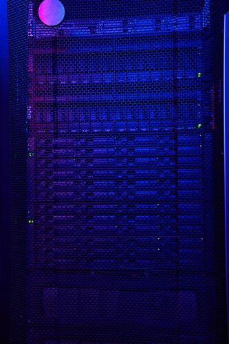 Close up image of dark server room with a lot of hard drives in data center